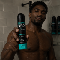 Man holding a 'Fresh Bro' men's intimate wash bottle in a bathroom.